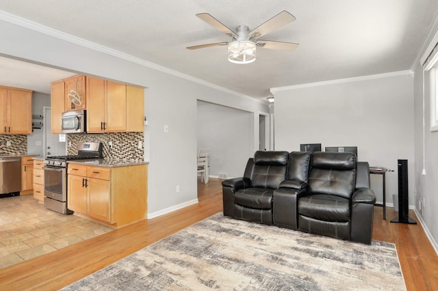 interior space with baseboards, crown molding, light wood-style floors, and a ceiling fan