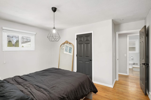 bedroom with light wood-style floors and baseboards