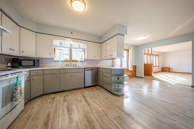 kitchen featuring white electric range oven, dishwasher, open floor plan, light countertops, and a sink