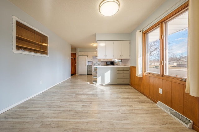 kitchen with open shelves, visible vents, light countertops, white cabinetry, and white appliances