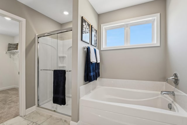 bathroom featuring shower with separate bathtub