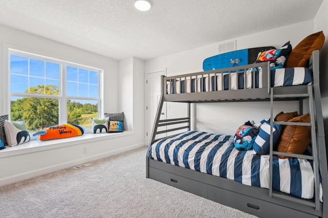 bedroom featuring carpet flooring and a textured ceiling