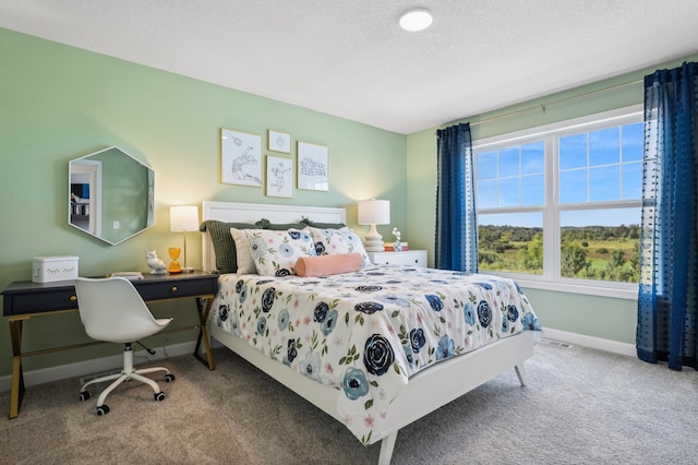 carpeted bedroom with a textured ceiling