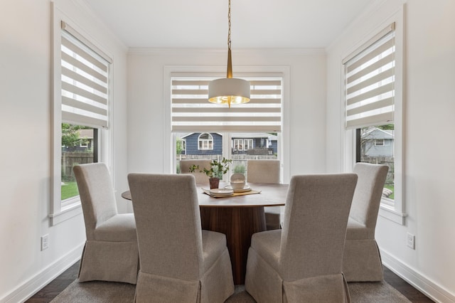 dining space with crown molding and dark hardwood / wood-style flooring