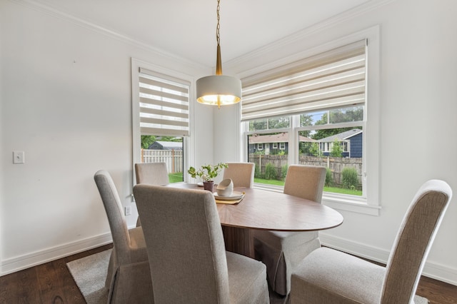 dining area with crown molding, plenty of natural light, and dark hardwood / wood-style floors