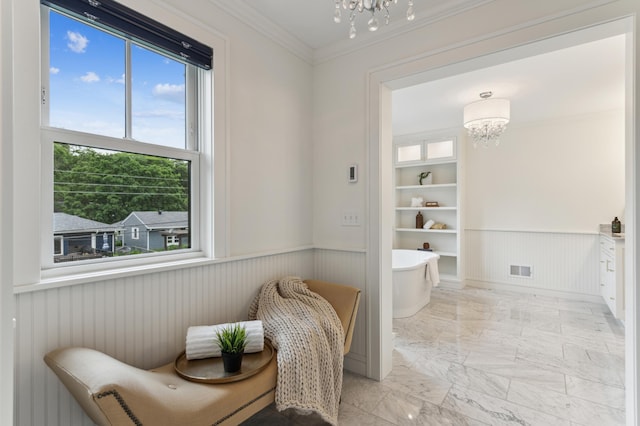 bathroom with crown molding, a chandelier, and built in shelves