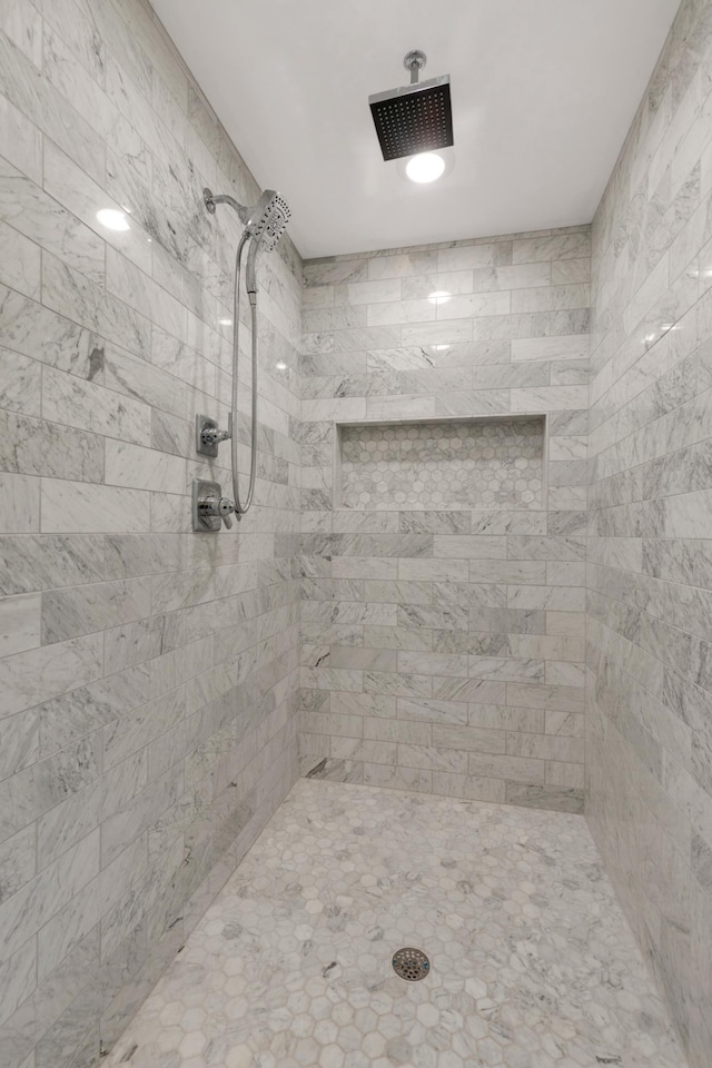 bathroom with tiled shower