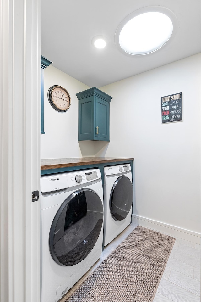 laundry area featuring cabinets and washing machine and dryer