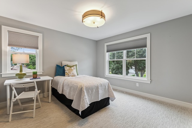 bedroom featuring light colored carpet