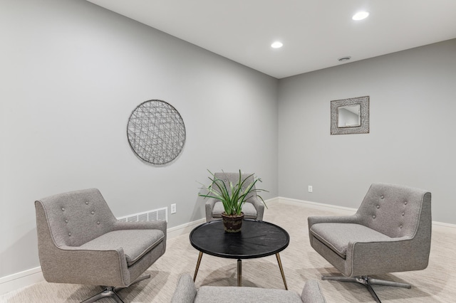 living area featuring light colored carpet