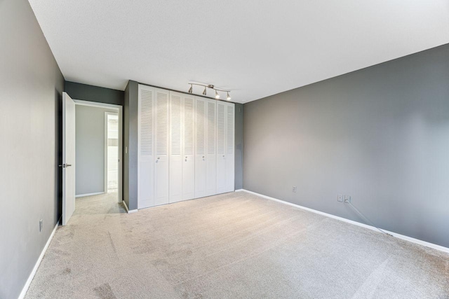 4380 Brookside Ct Unit 116, Edina, MN 55436 - unfurnished bedroom with carpet flooring, a closet, and rail lighting