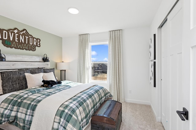 carpeted bedroom with baseboards