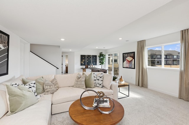 living area featuring recessed lighting, light carpet, and baseboards