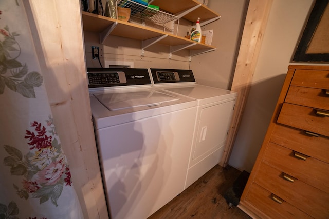 clothes washing area featuring dark hardwood / wood-style flooring and washing machine and clothes dryer