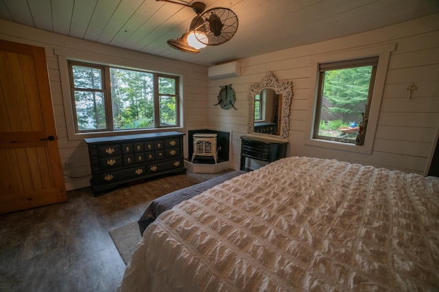 3835 Lake Rd, Barnum Twp, MN 55767 - bedroom with a wall mounted AC, wood walls, and wood finished floors