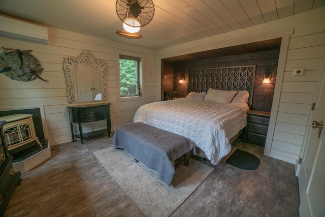 3835 Lake Rd, Barnum Twp, MN 55767 - bedroom with wood walls, wood finished floors, a wood stove, and a wall mounted AC