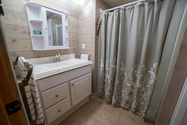 3835 Lake Rd, Barnum Twp, MN 55767 - bathroom featuring tile patterned flooring, vanity, vaulted ceiling, wood walls, and a shower with curtain