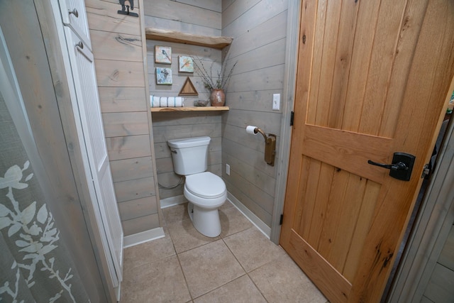 3835 Lake Rd, Barnum Twp, MN 55767 - bathroom with toilet, tile patterned flooring, and wooden walls