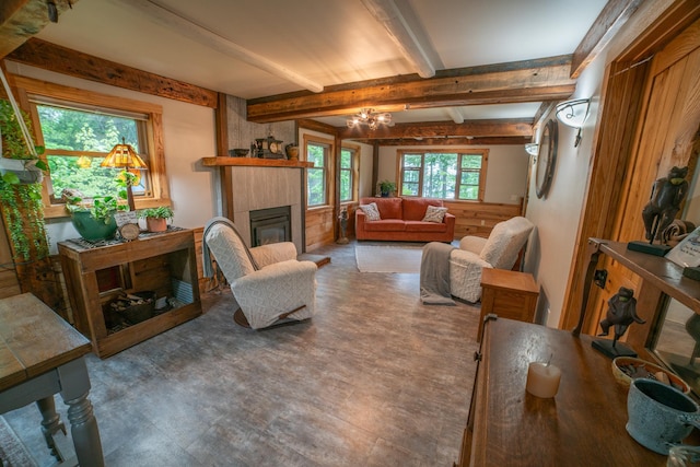 3835 Lake Rd, Barnum Twp, MN 55767 - living room featuring a fireplace, beam ceiling, and a chandelier