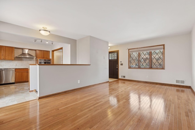 unfurnished living room with light wood-type flooring