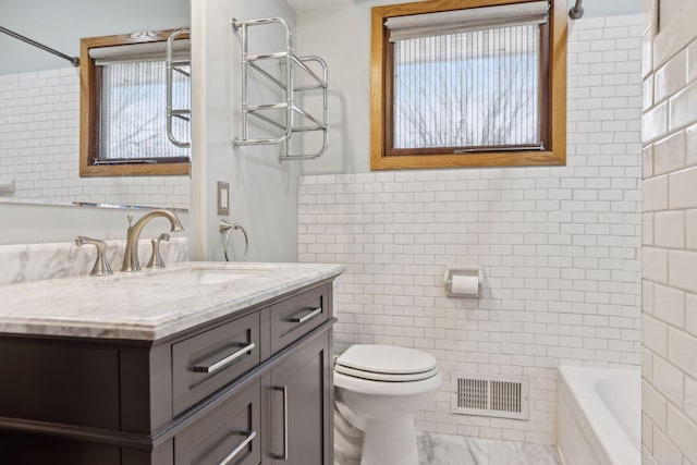 full bathroom featuring vanity, tile walls,  shower combination, and toilet