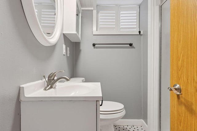 bathroom with vanity, toilet, and tile patterned flooring