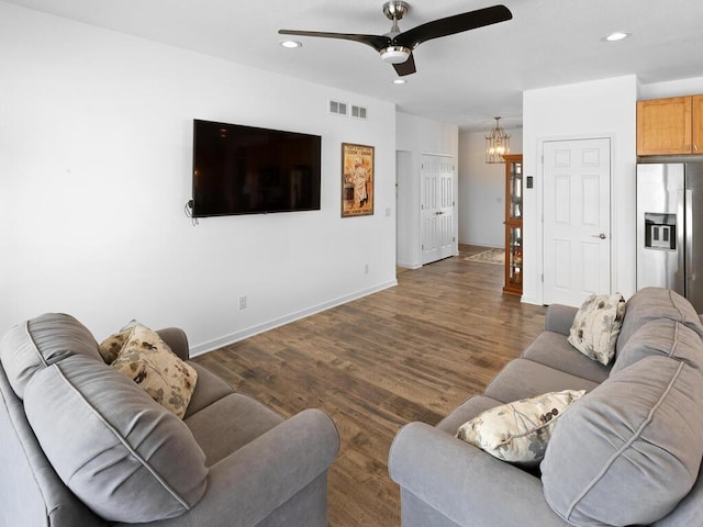 living area featuring visible vents, ceiling fan with notable chandelier, wood finished floors, recessed lighting, and baseboards