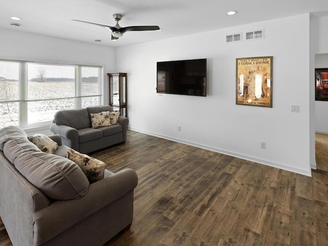 living area featuring baseboards, visible vents, recessed lighting, ceiling fan, and dark wood-type flooring