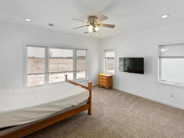 bedroom with recessed lighting, light colored carpet, baseboards, and ceiling fan