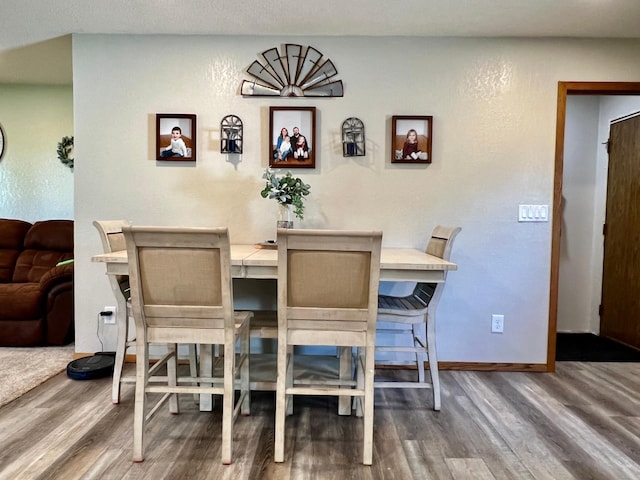 dining area with wood-type flooring