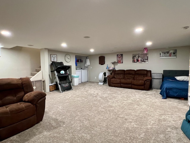 carpeted living room featuring washing machine and clothes dryer