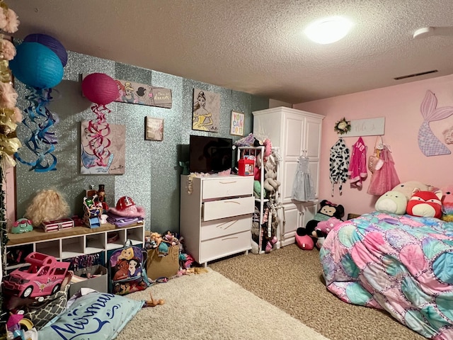 bedroom with carpet and a textured ceiling