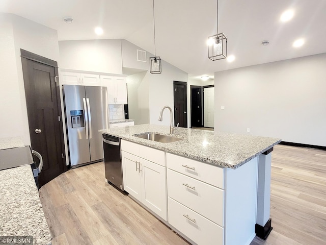 kitchen with an island with sink, appliances with stainless steel finishes, sink, and white cabinets