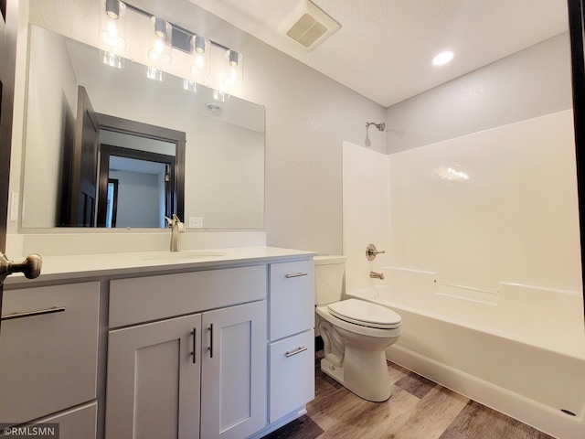 full bathroom featuring vanity, toilet, shower / bath combination, and hardwood / wood-style floors