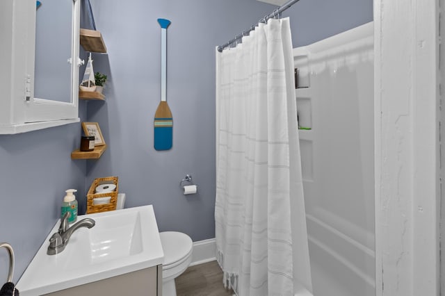 full bathroom featuring toilet, vanity, and shower / bath combo with shower curtain