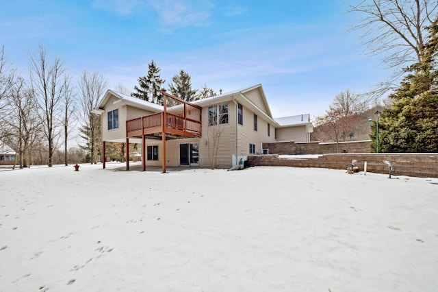 snow covered property featuring a wooden deck