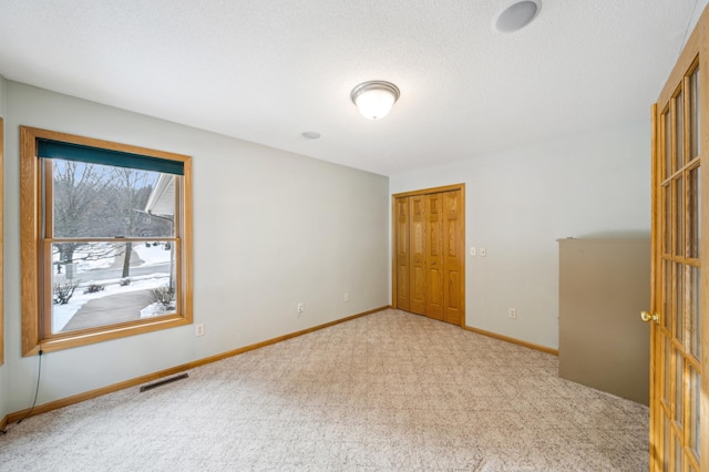 empty room with light colored carpet