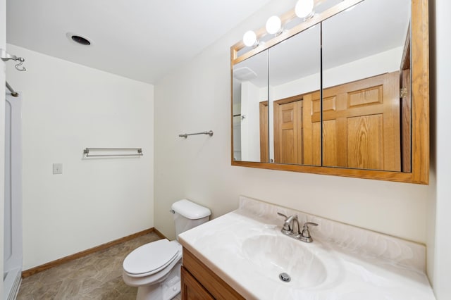 bathroom featuring vanity, tile patterned floors, and toilet