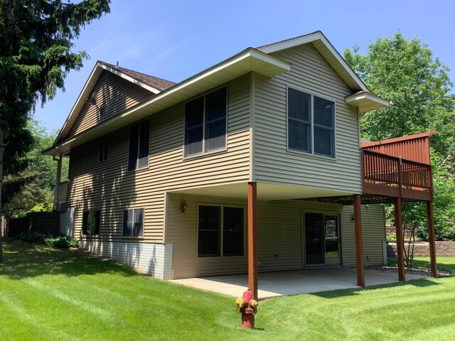 1382 Riverside Dr Unit 1382, River Falls, WI 54022 - back of house featuring a yard, a wooden deck, and a patio
