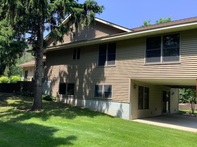 1382 Riverside Dr Unit 1382, River Falls, WI 54022 - view of side of home with a lawn and a carport