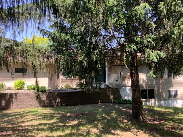 1382 Riverside Dr Unit 1382, River Falls, WI 54022 - view of property hidden behind natural elements featuring a front lawn