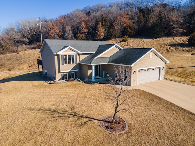 view of front of house with a garage and a front lawn