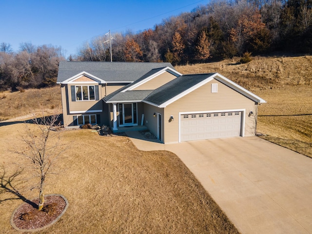 view of front of home with a garage and a front lawn