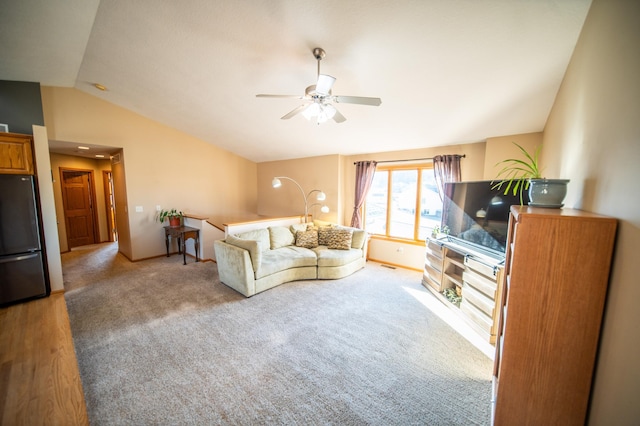 carpeted living room with vaulted ceiling and ceiling fan