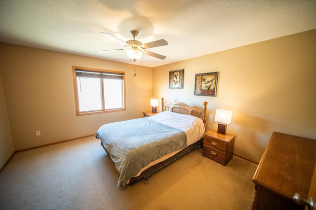 carpeted bedroom featuring a textured ceiling and ceiling fan