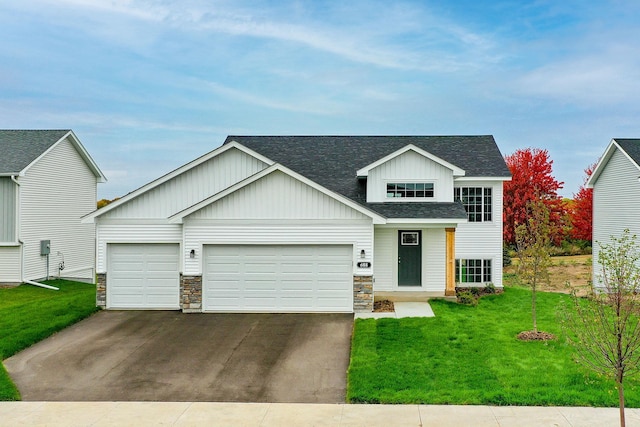 view of front of property with a garage and a front lawn