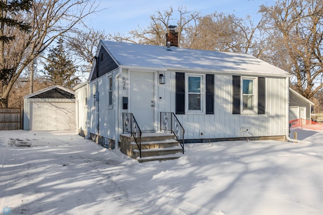 view of front of house with a garage and an outdoor structure