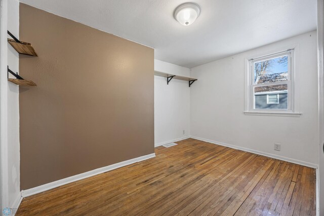 unfurnished room featuring hardwood / wood-style flooring