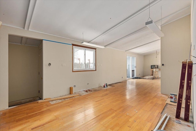 interior space featuring vaulted ceiling with beams and hardwood / wood-style floors