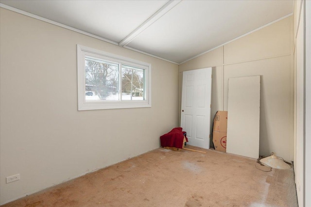 unfurnished room featuring lofted ceiling and carpet floors